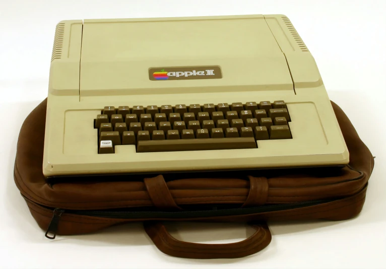 an old fashioned computer with a brown case