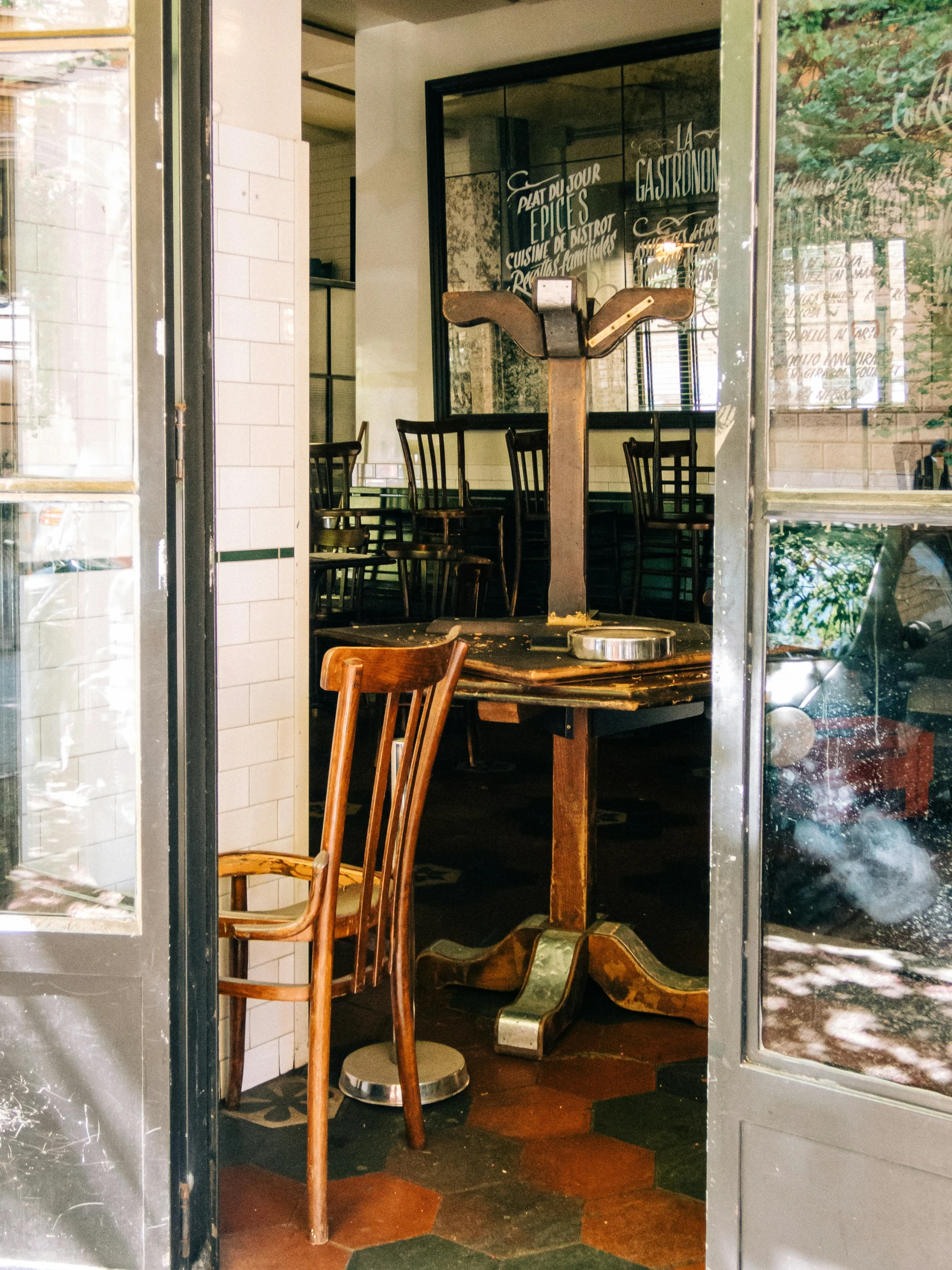 an open door with a wooden table and chair