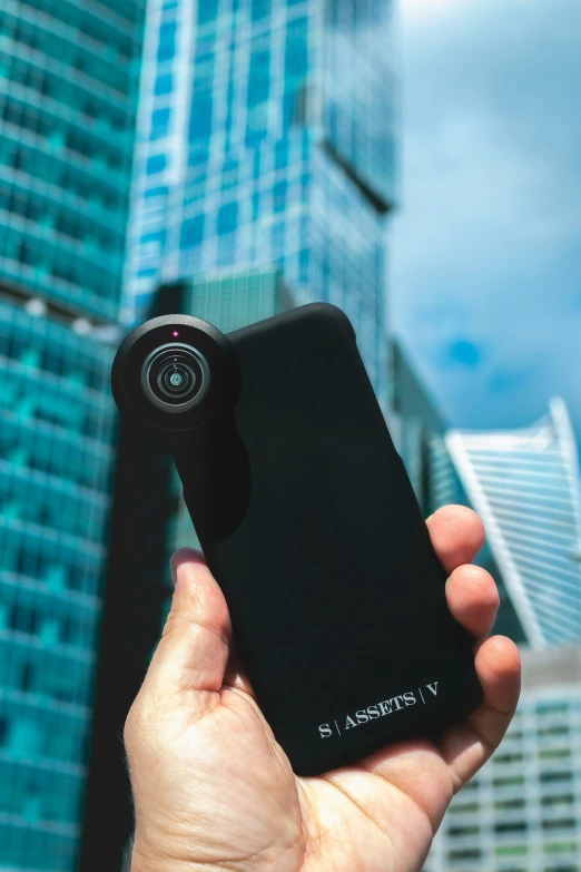 a person is holding a camera outside the city