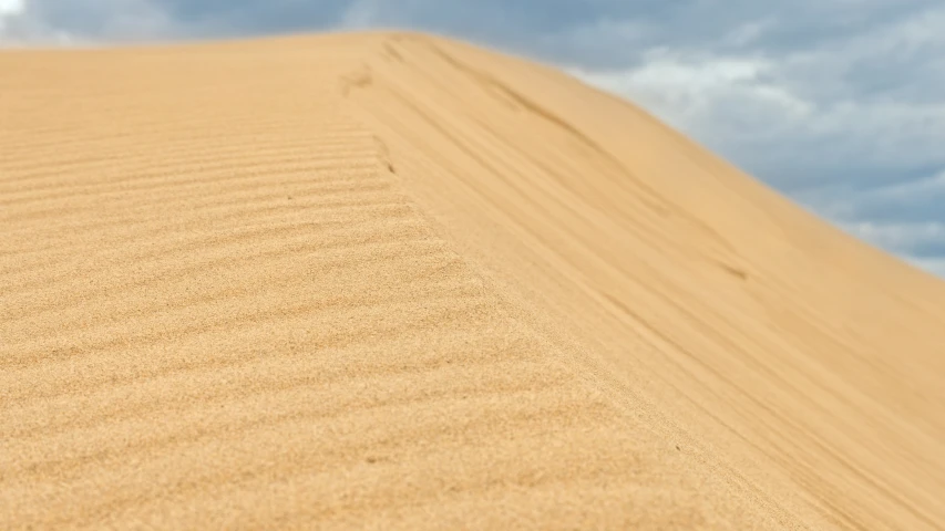 there is a large dune in the middle of the desert