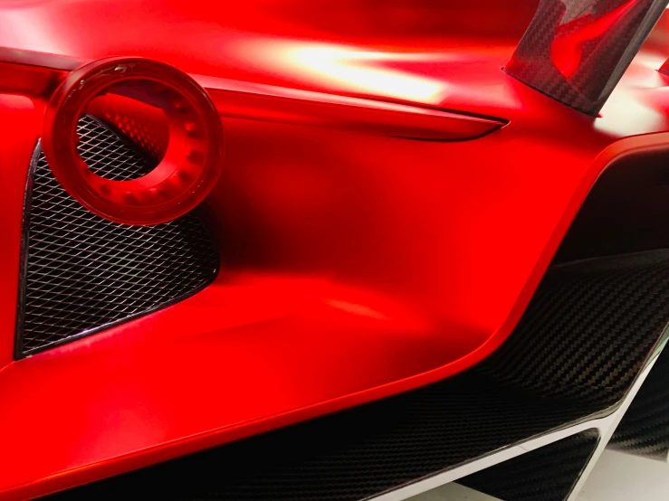 a close up of a red car's hood