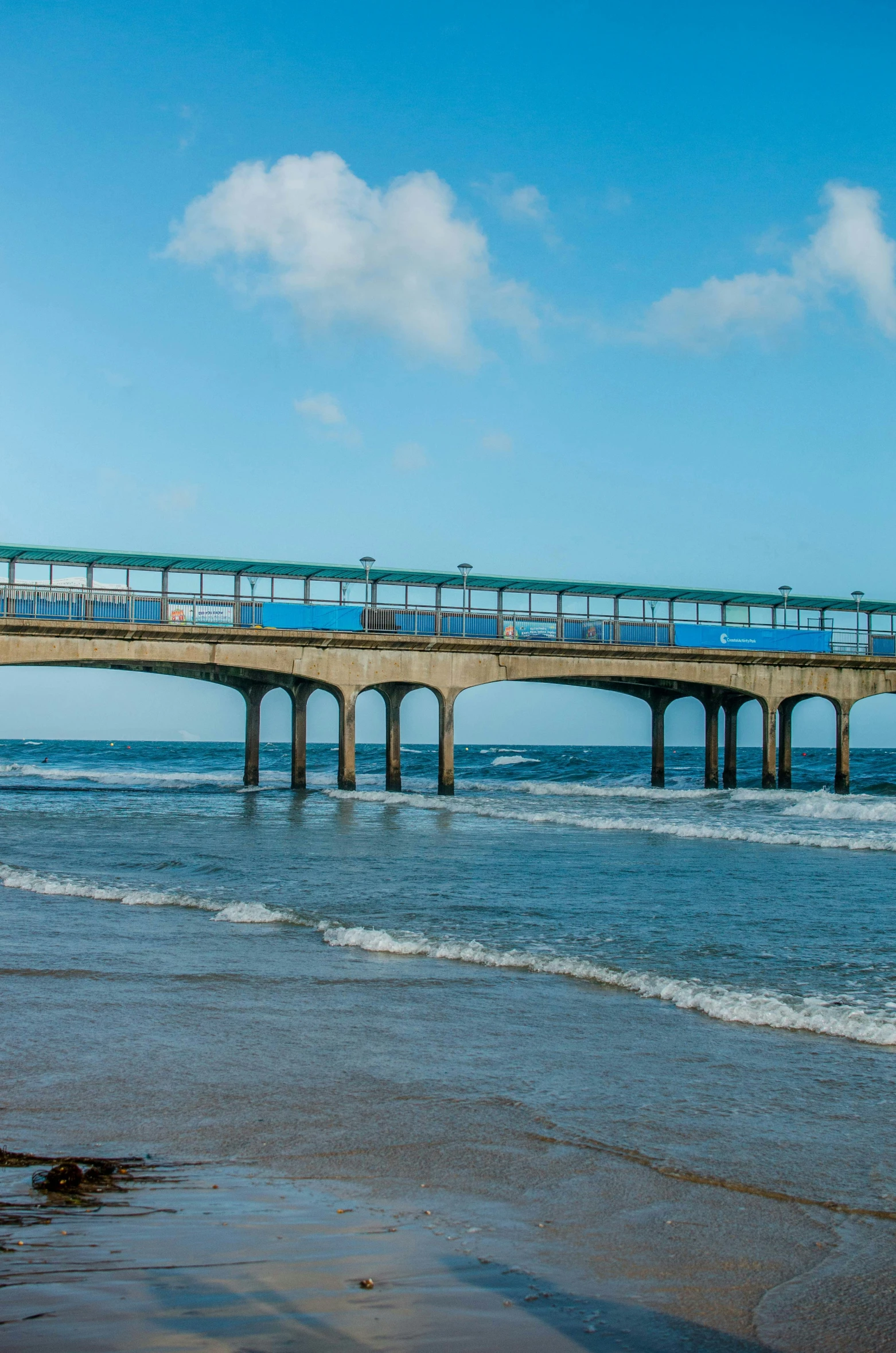 an elevated train crossing over water on a pier