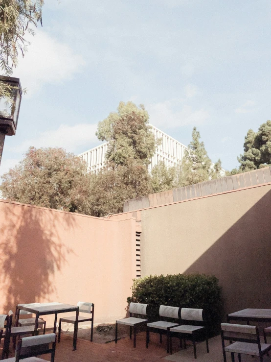 patio seating is arranged along the side of a building