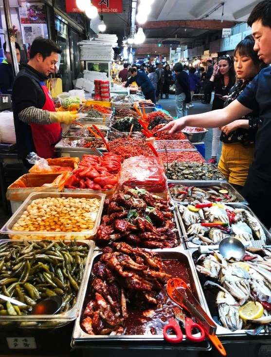 there are several trays of food on display