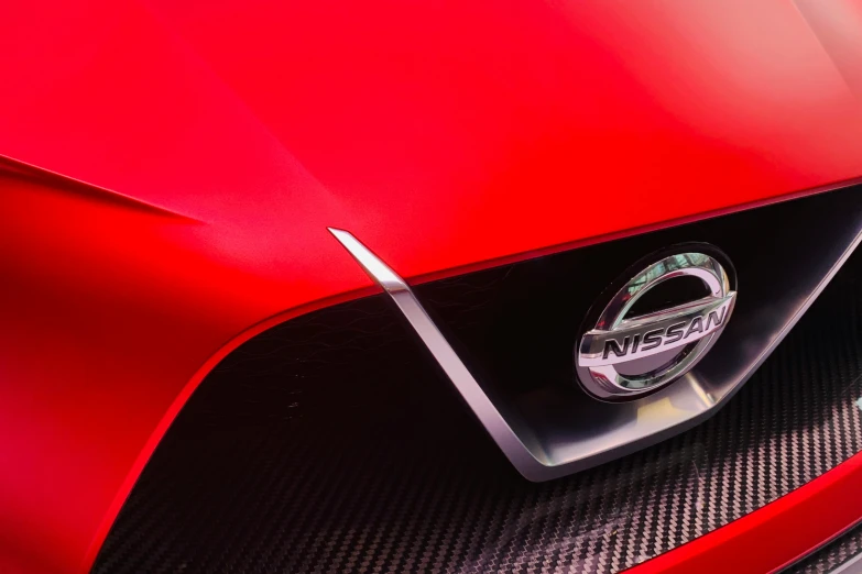 a close up of the badge on the front of a red car