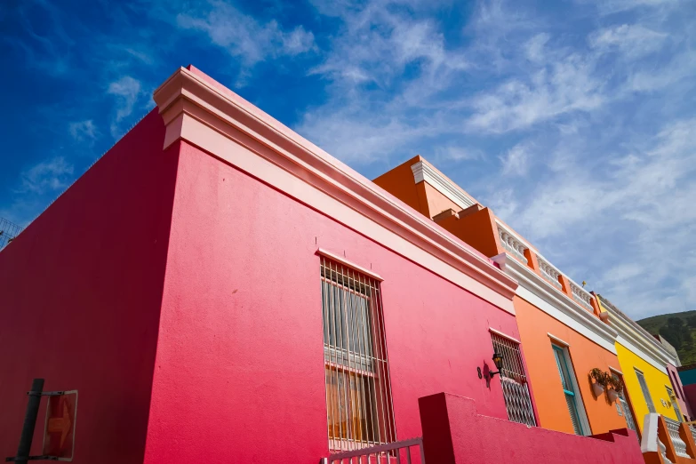 a large pink house that is in a small town