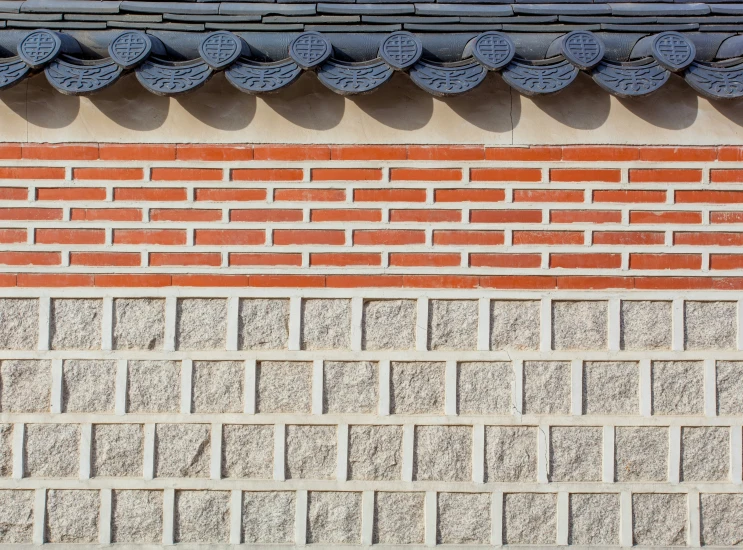 the side of a brick building with a roof fan