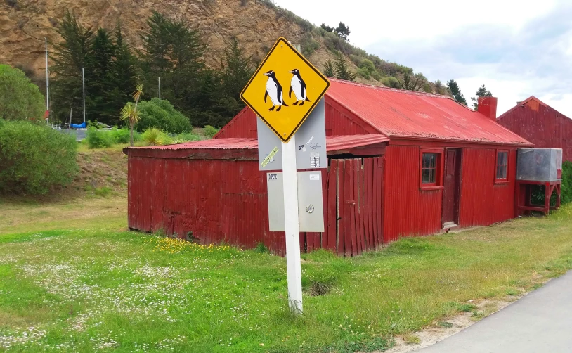 a sign in front of a building and a red roof