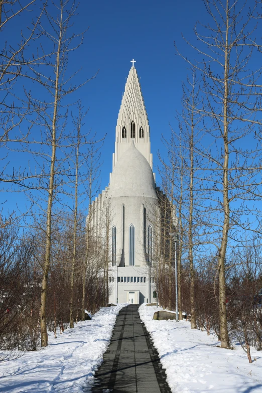 a small church tower standing next to several trees