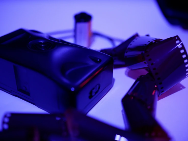 a black video camera on a table next to other items