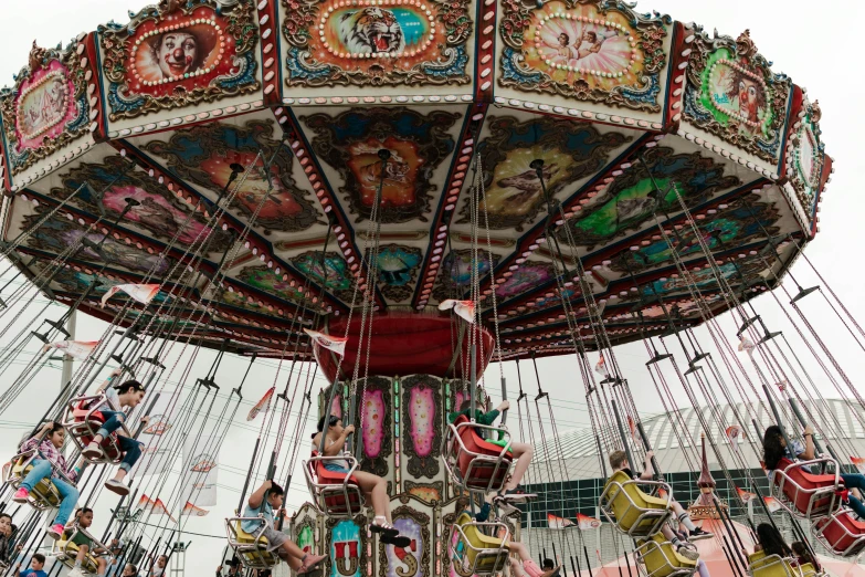 an old fashioned carousel has several merry go round seats