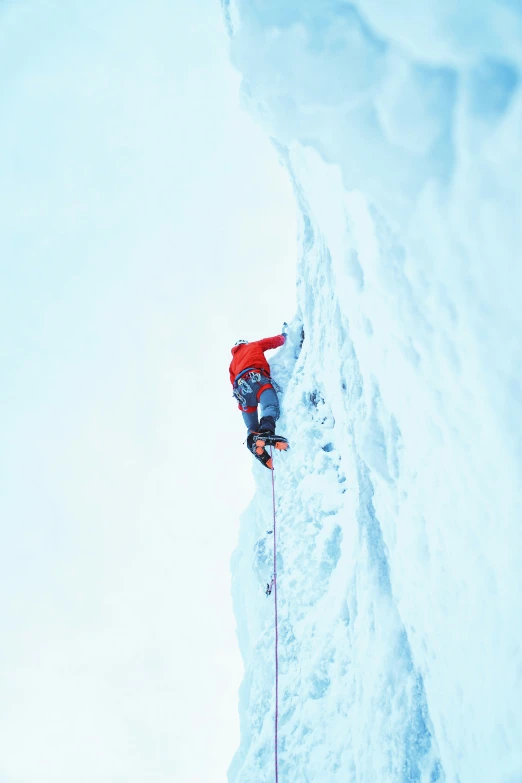 a skier is climbing up the side of a mountain