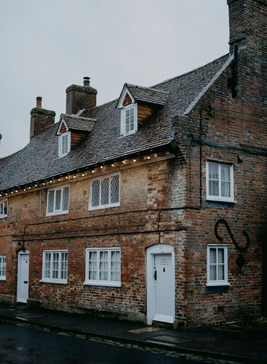 an old brick building with white windows