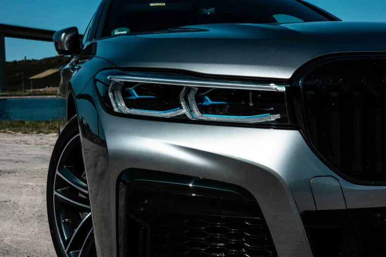 the grill and front lights of a grey bmw suv