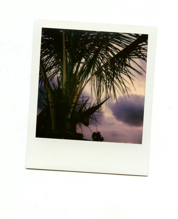 a polaroid pograph of the sky with clouds