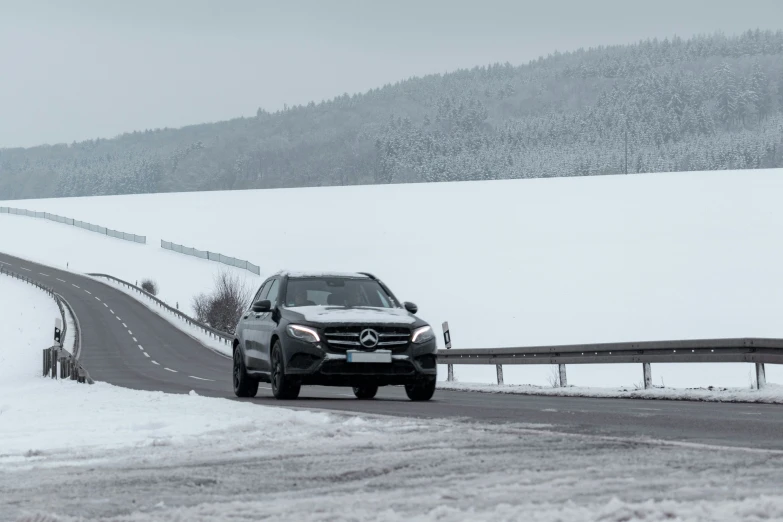 a car is driving down a snowy road