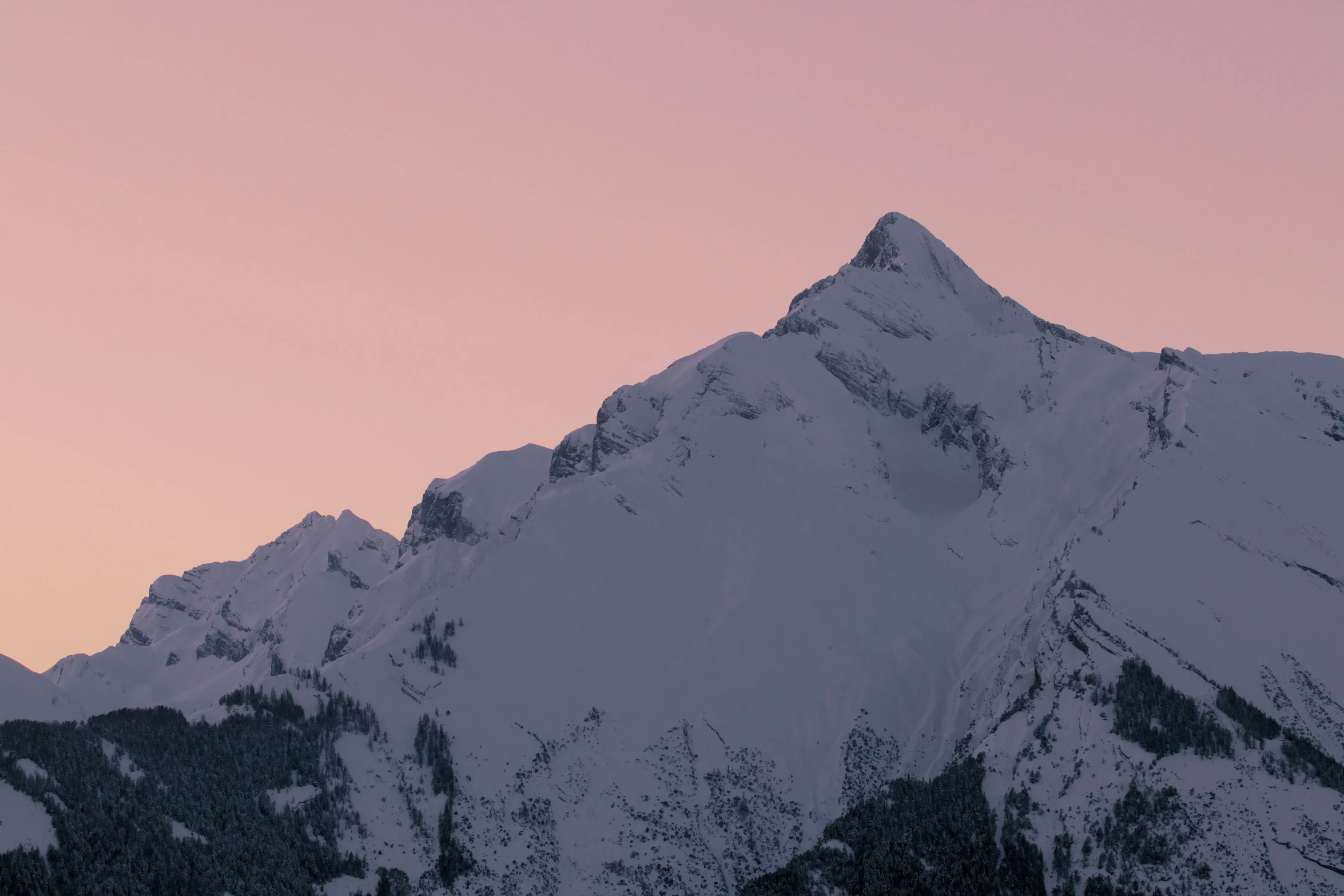 a view of a snow covered mountain with one skis sticking out of it