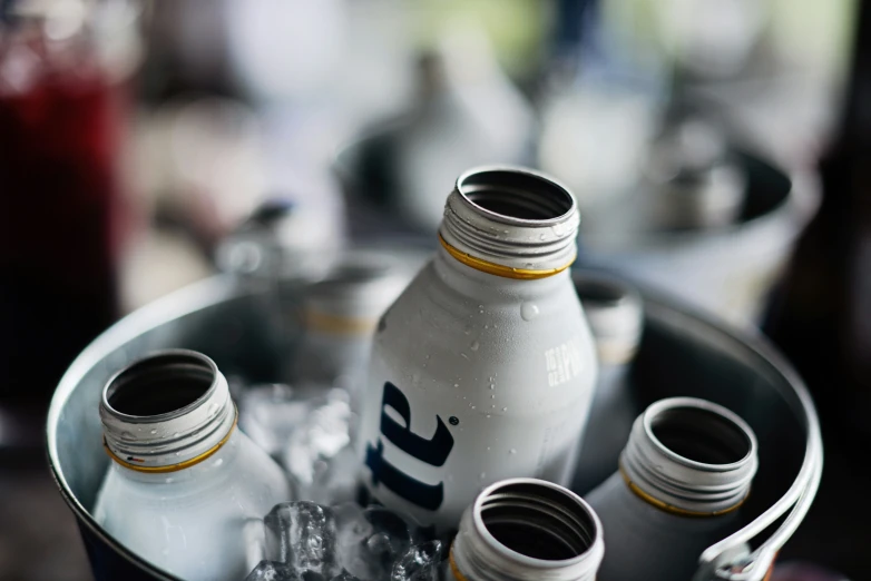 a couple of bottles in a bowl with some ice