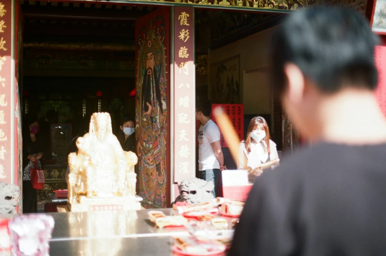 a group of people standing at a chinese style temple