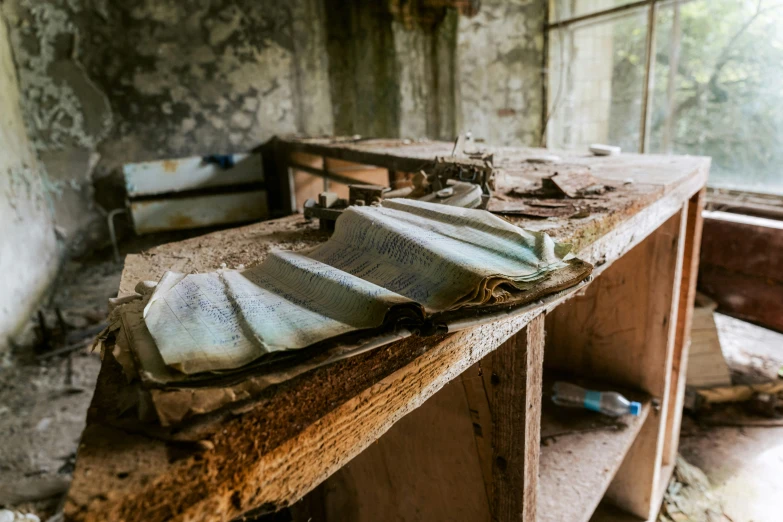 a dirty bench and desk in an old room