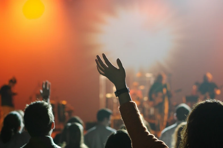 people raising their hands at the same time