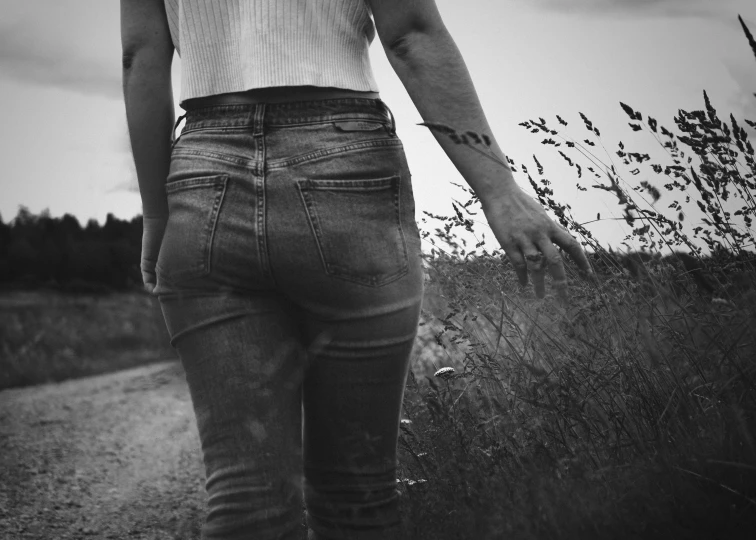 a person standing in front of a grass field