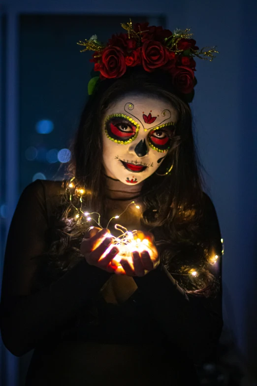 woman wearing makeup and skull make up with a lite - up ball