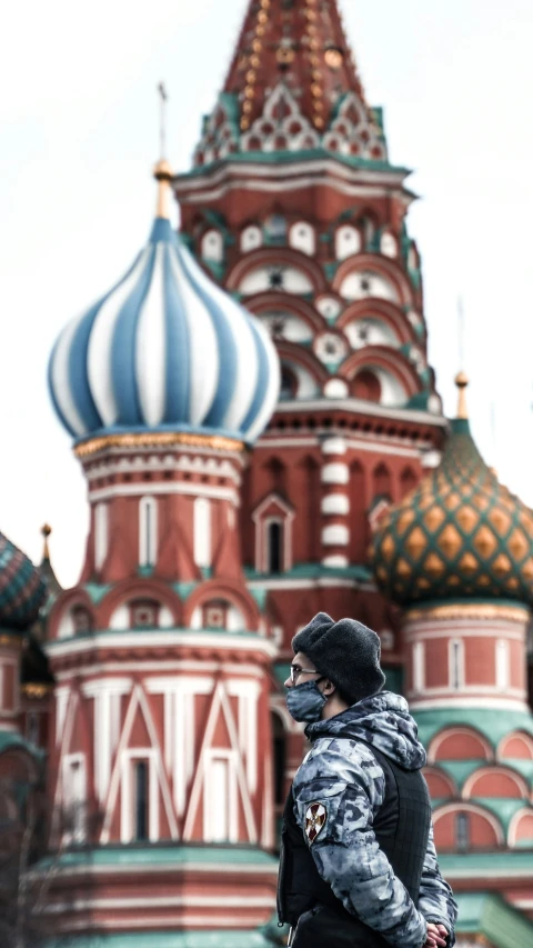 the person in black jacket is standing in front of the building