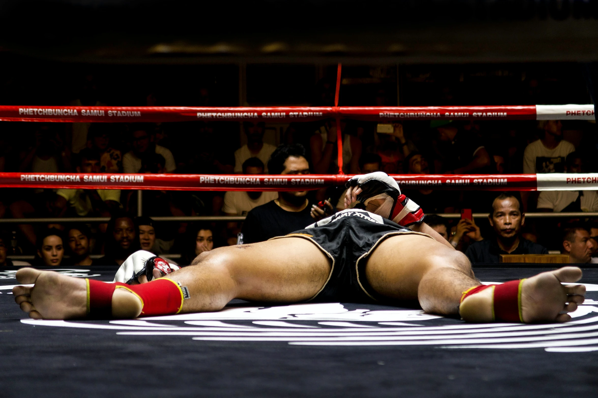 a wrestlers chest laying in a boxing ring