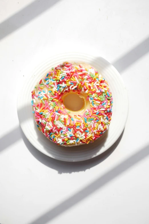 a colorful doughnut with white icing and sprinkles on top