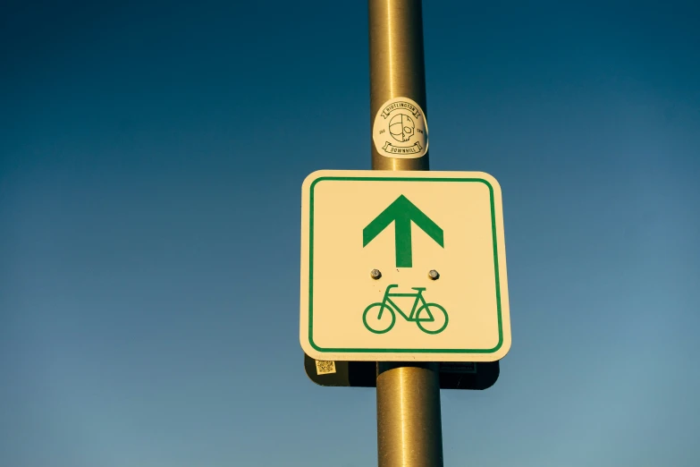 there is a green and white street sign with an arrow