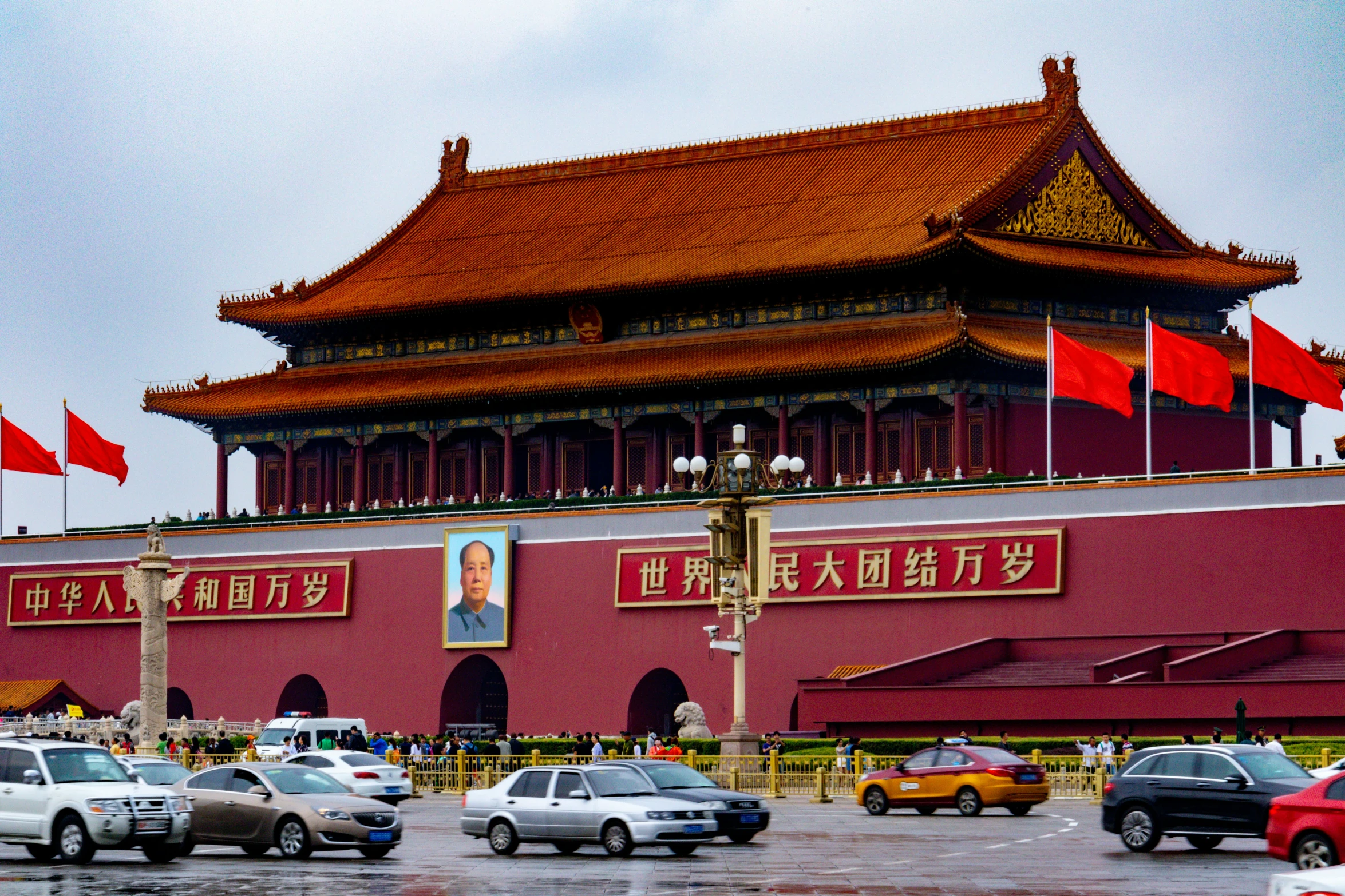 a large building sitting over a street filled with cars