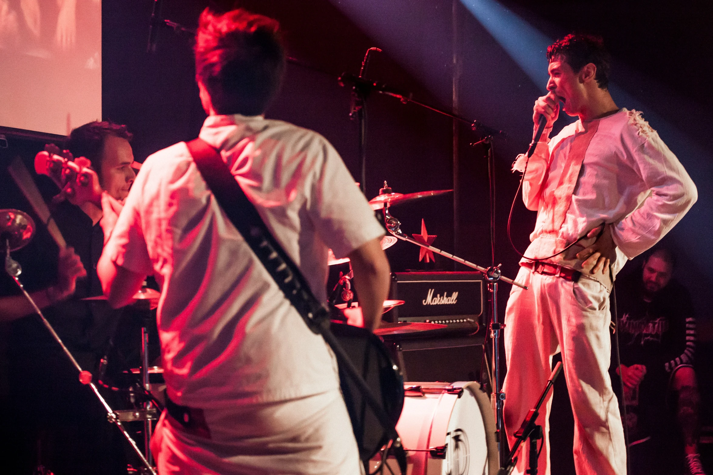 some musicians and a woman standing on stage