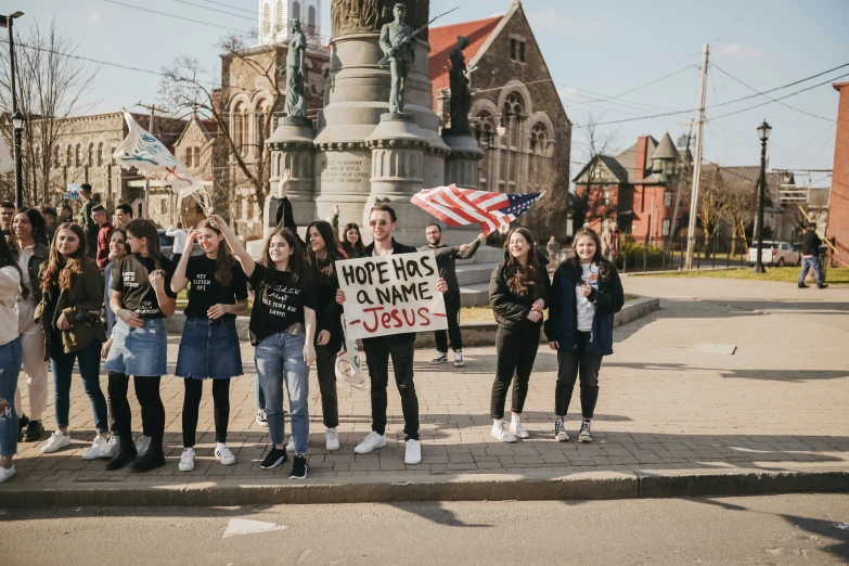 several people holding a sign on the street