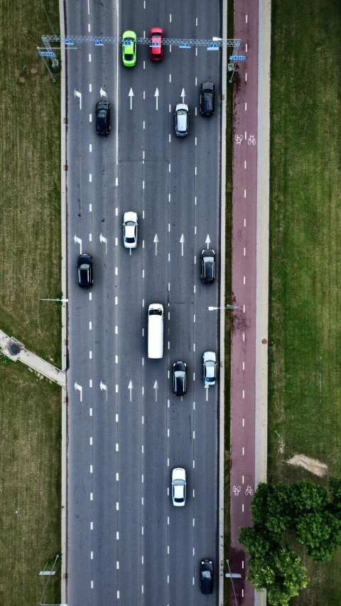 cars and trucks are driving down a two way road