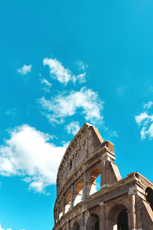 the ancient colossion beneath a blue sky with clouds