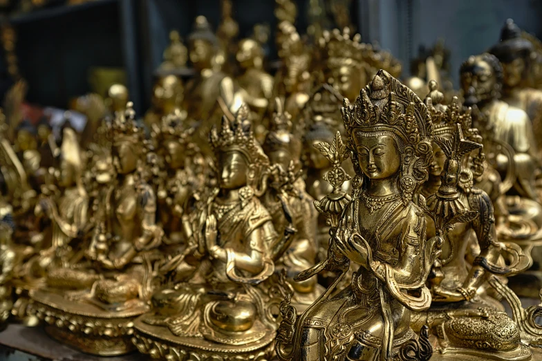 several golden statues sitting on top of a table