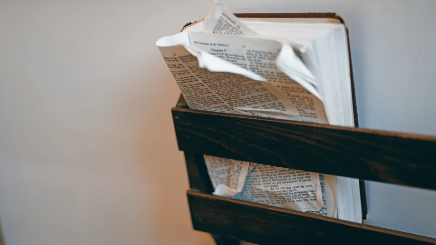 there is some newspapers on top of the bed