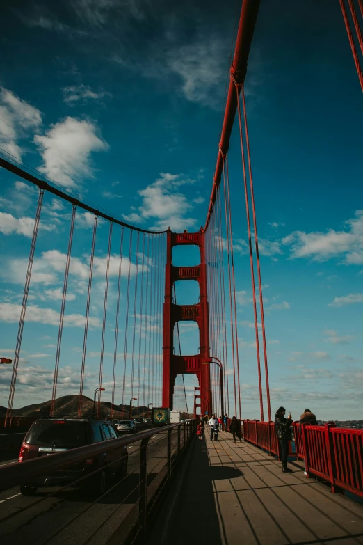 a view of the suspension bridge as cars drive along