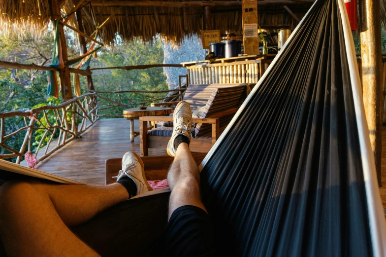 man resting in hammock looking out over jungle