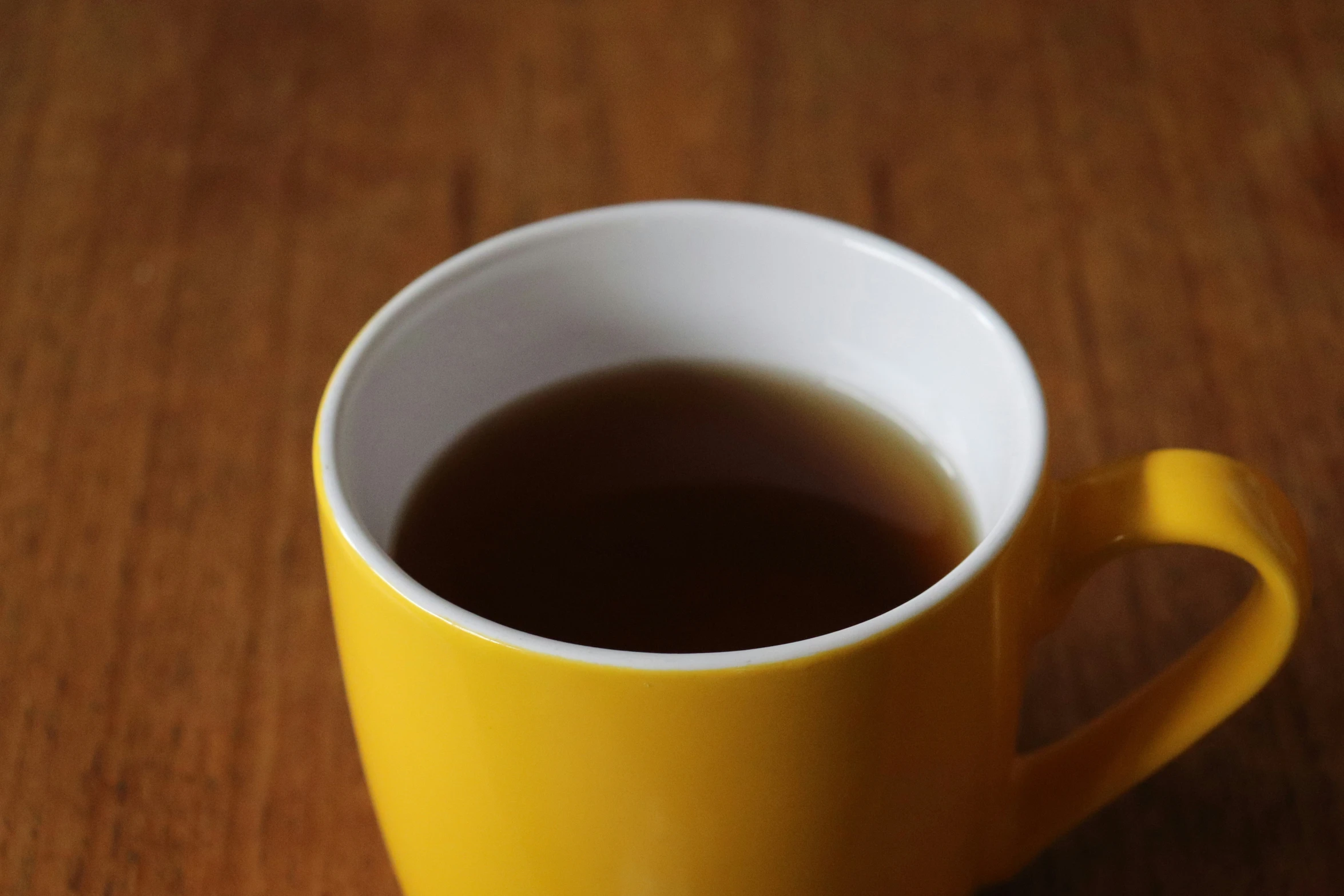 there is a cup filled with tea sitting on the table