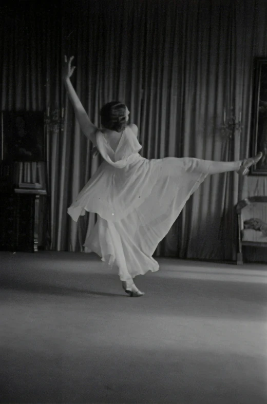 a woman in a dress doing a ballet move