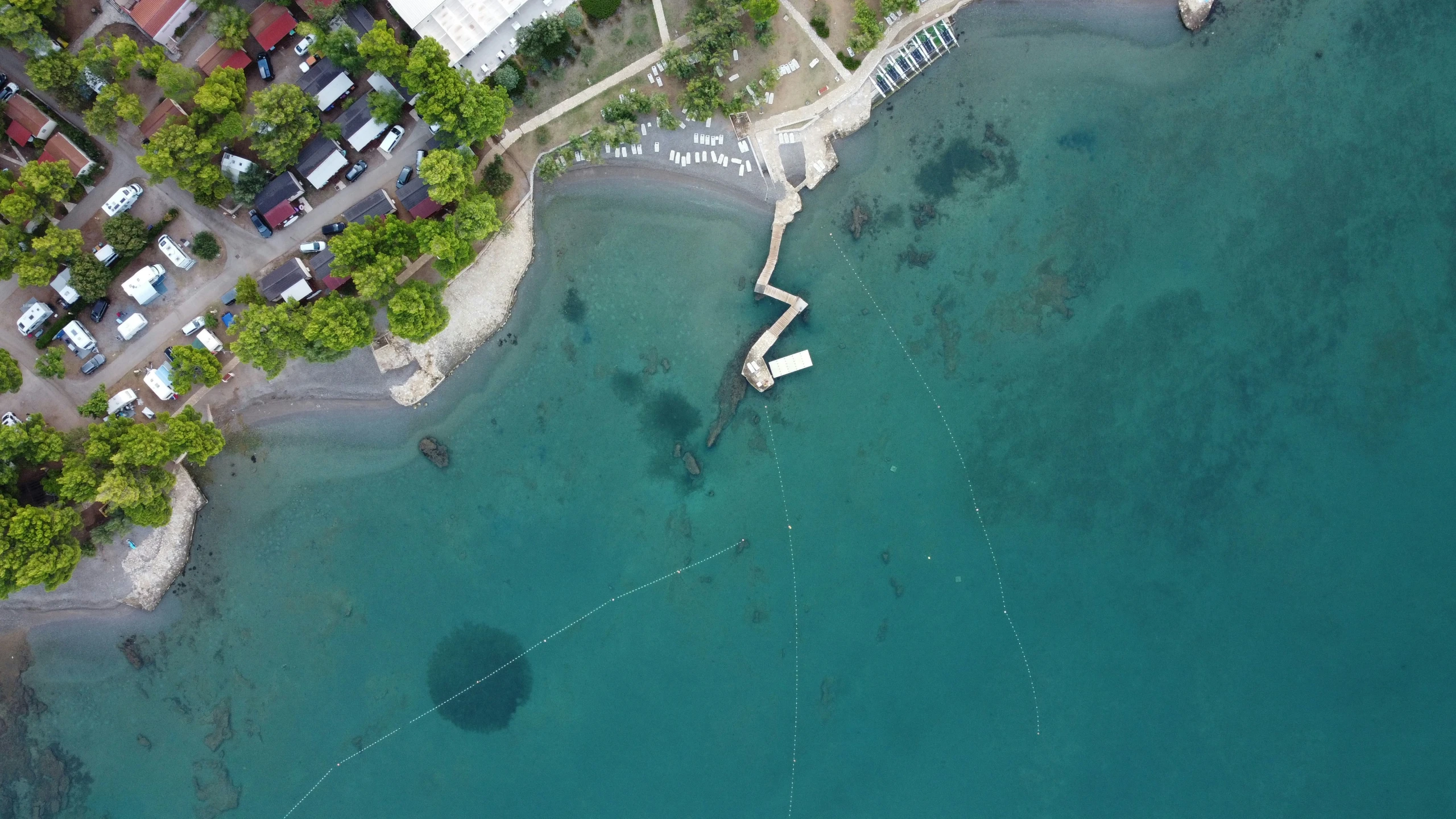 an aerial view shows some houses along the edge of the water