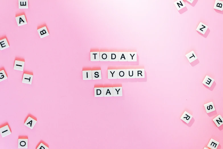 the letters made with scrabble tiles and paper blocks reading today is your day