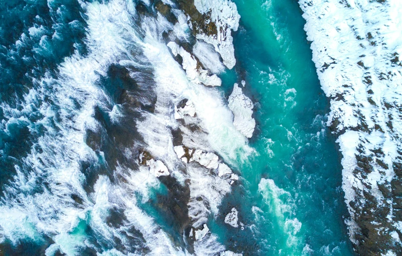 an aerial po of a river in winter