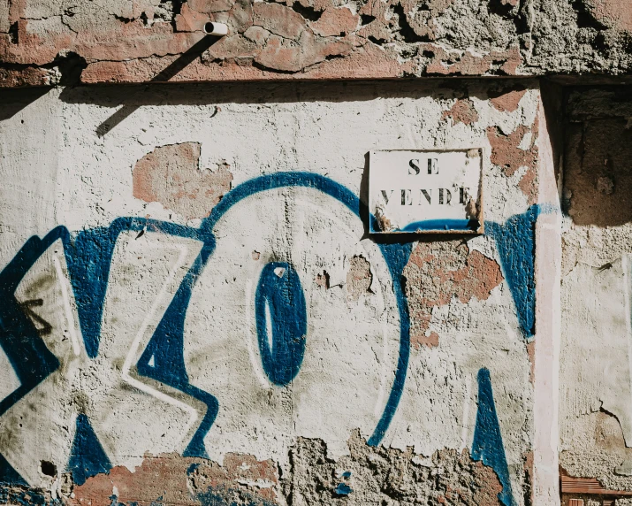 graffiti is painted on the wall of an older brick building