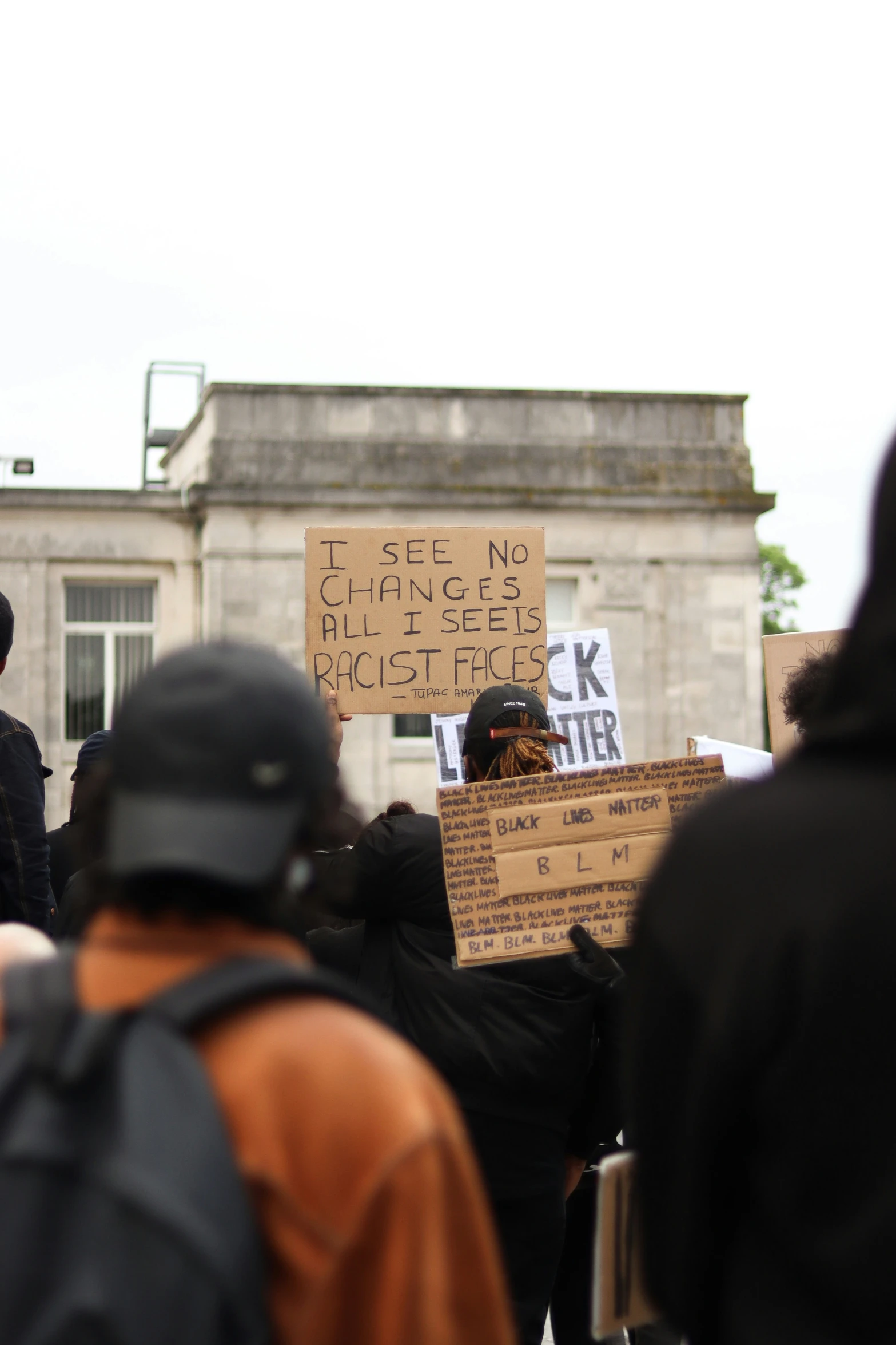 protesters march and hold signs with the government