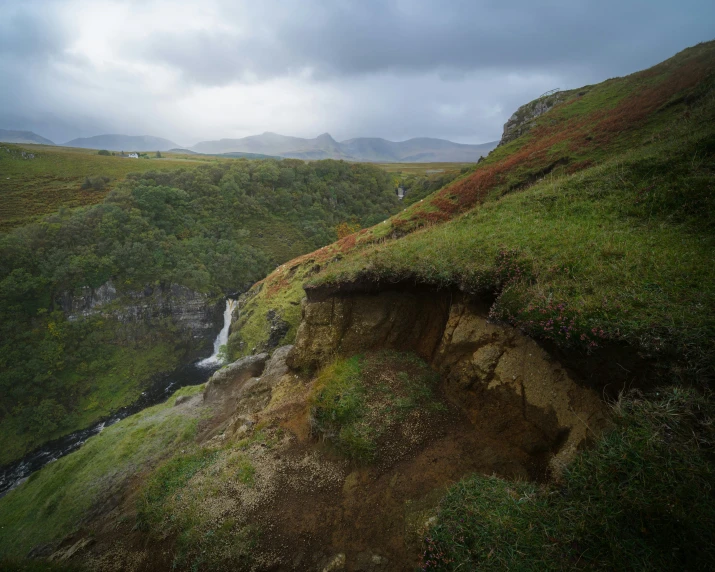 a mountain with a river flowing down the side of it