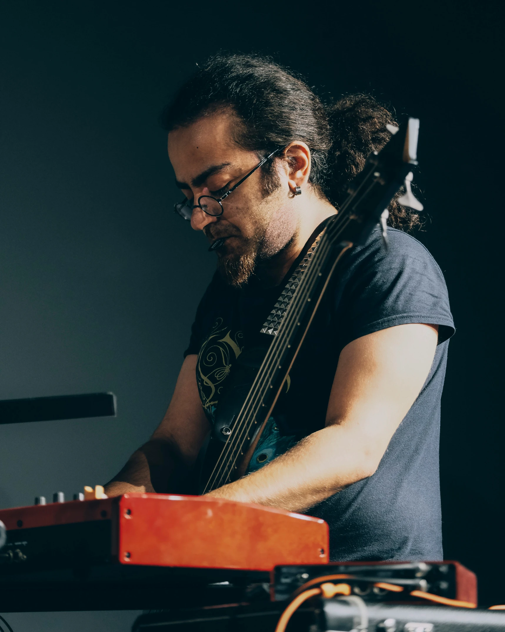 man playing musical instrument in front of microphone