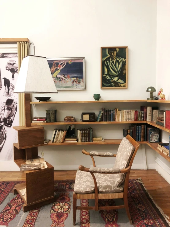 a living room with two chairs and two shelves